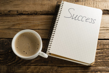 Coffee and diary. Notepads. A note. Success.