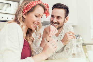 Cute couple having breakfast at home