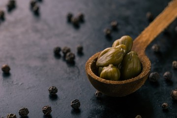 Vintage wooden spoon with capers