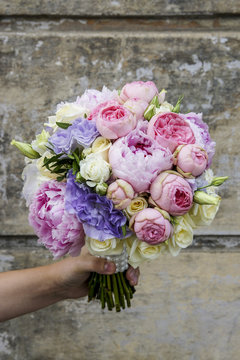 Wedding bouquet with peonies, roses and eustoma flowers.