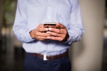 Business executive holding mobile phone