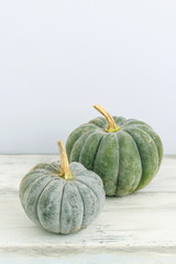 Green pumpkins on wood