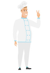 Caucasian chef cook showing the victory gesture.