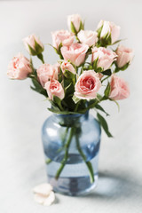 Pink spray roses in blue vase