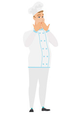 Shoked caucasian chef cook covering his mouth.