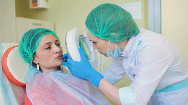 Cosmetology doctor female reviewing of her pation in medical clinic