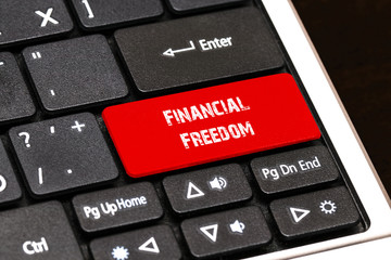On the laptop keyboard the red button written Financial Freedom