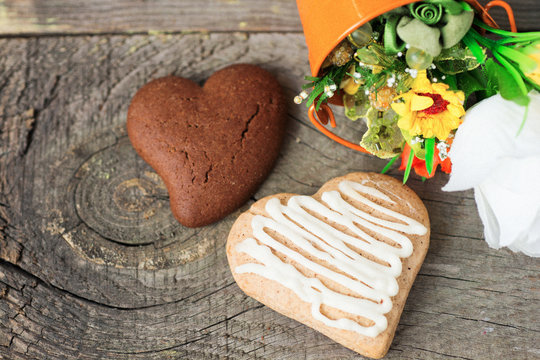 Heart shaped cookies (big and small as couple), cup of coffee, bouquet of flowers decoration. sunny morning. Romantic breakfast or Valentine's Day Breakfast. Toned image 