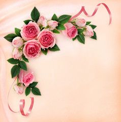 Pink rose flowers and ribbons corner arrangement on silk