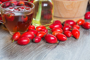 Medicinal plants and herbs composition Pile of dried rose hips and Dog rose, bunch branch Rosehips, types Rosa canina. Herbal tea 
