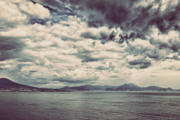 View of a mountain landscape and the sea horizon under the storm clouds