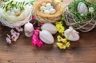 Beautiful Easter eggs with flowers on the wooden background