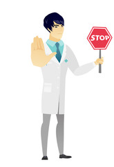 Asian doctor holding stop road sign.