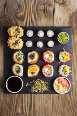 Various kinds of sushi served on a black stone