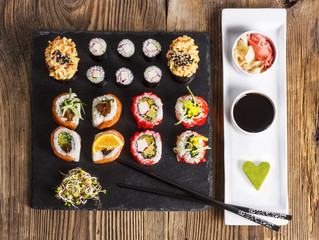 Sushi set on a dark stone, soy sauce, wasabi and ginger