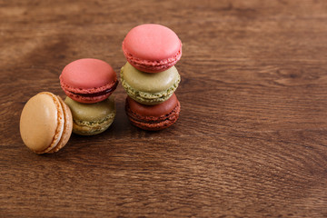 Macaroon cakes. Different types of macaron. Colorful almond cookies. French sweet dessert. Wooden rustic board.