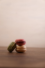 Macaroon cakes. Different types of macaron. Colorful almond cookies. French sweet dessert. Wooden rustic board.