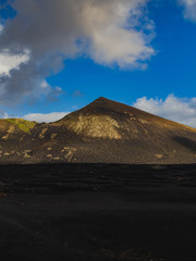 Fototapeta na wymiar Wide view of Volcanic Landscape with Mountain in Distance