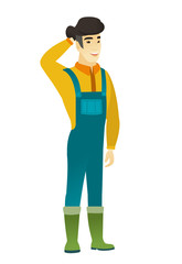 Asian farmer holding hand behind head.