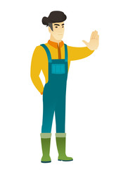 Asian farmer showing stop hand gesture.