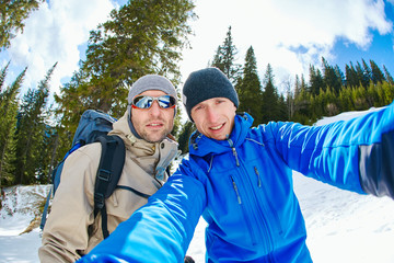 hikers make selfie in the winter mountains