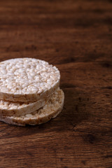 Rice biscuits on grunge rustic wood background. Natural organic diet food. Wooden vintage board.