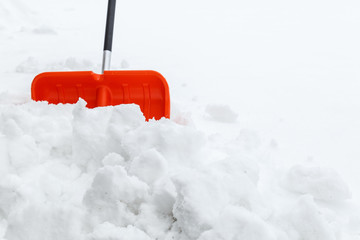 Winter shoveling. Removing snow after blizzard. Shovel which cleaning snow.