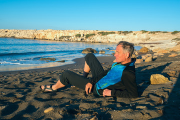 Sporty man traveler relax on the seaside