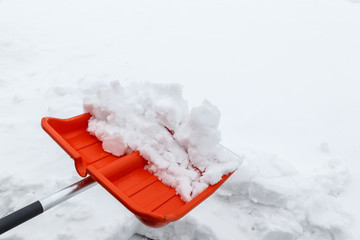 Winter shoveling. Removing snow after blizzard. Shovel which cleaning snow.