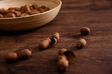 Sweet tamarind on grunge rustic wood background. Natural organic diet food with a lot of vitamins....
