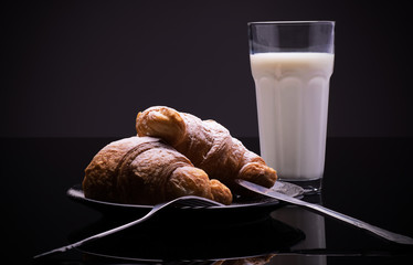 Fresh croissants with glass of milk