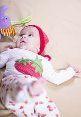 Adorable baby in the bedroom. Newborn child relaxing in bed. Nursery for young children. Textile and bedding for kids. Family morning at home.