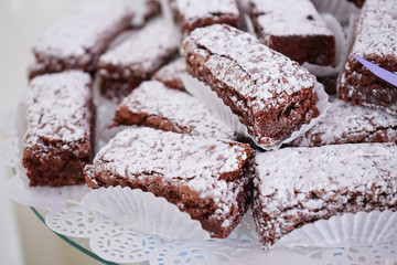 Brownie with glazed sugar in the top, on a white table on a white background.