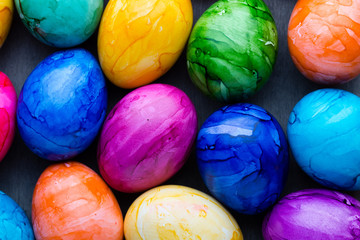 Easter eggs painted in colors on a pattern background.