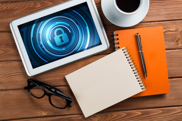 Web security and technology concept with tablet pc on wooden table