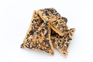 Crisps with nuts and seeds stacked on a white background.