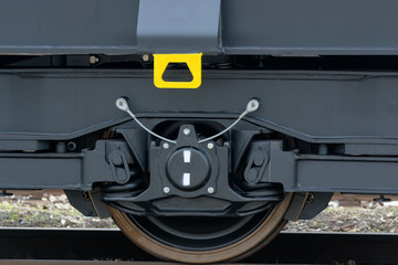 Obraz na płótnie Canvas Bumper and coupler - hang rail car .Freight (cargo) train - black cars (wagons). New 6-axled flat wagon ,Type: Sahmmn, Model WW 604 A, Transvagon AD