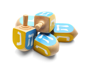 Wooden dreidels for Hanukkah on white background