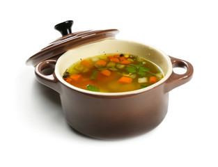 Fresh vegetable soup in pan on white background