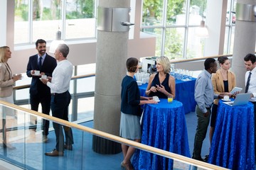 Business executives interacting with each other during break