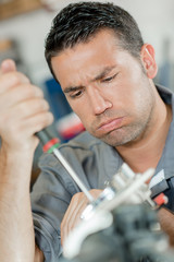 Fototapeta premium Working mechanic, frustrated expression