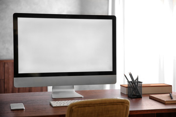 Modern computer monitor on wooden desk