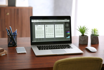 Modern laptop on wooden desk