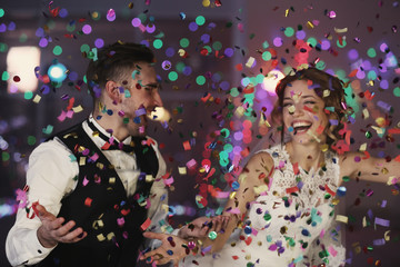 Cute happy wedding couple against defocused lights © Africa Studio