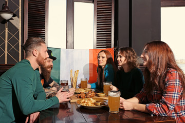 People celebrating Saint Patrick's Day in pub