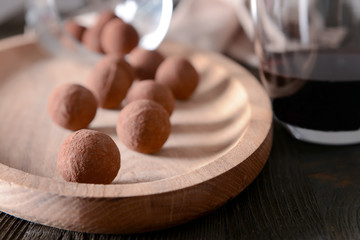 Delicious chocolate truffles and red wine closeup