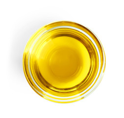 Top view of glass with olive oil on white background