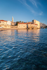 Fototapeta na wymiar Ancient stone buildings by the sea at sunset in old town Budva, Montenegro