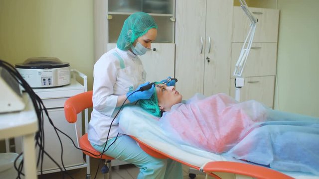 Cosmetology doctor female makes treatment procedure her patient in medical center