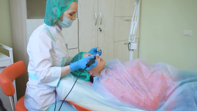 Cosmetology doctor female makes treatment procedure her patient in medical center